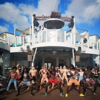 A group of people dancing at a bar