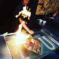 A chef cooking at a grill