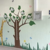 A paper tree in a class room stuck to a wall