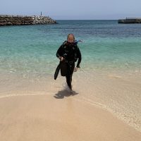 Someone coming from the sea in scuba wear